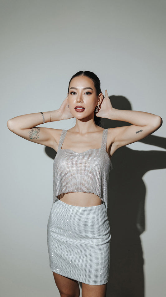 a girl in a sparkling top made of crystals